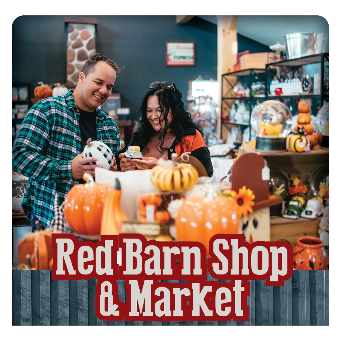 People at a gift shop with many fall-themed souvenirs and crafted items.